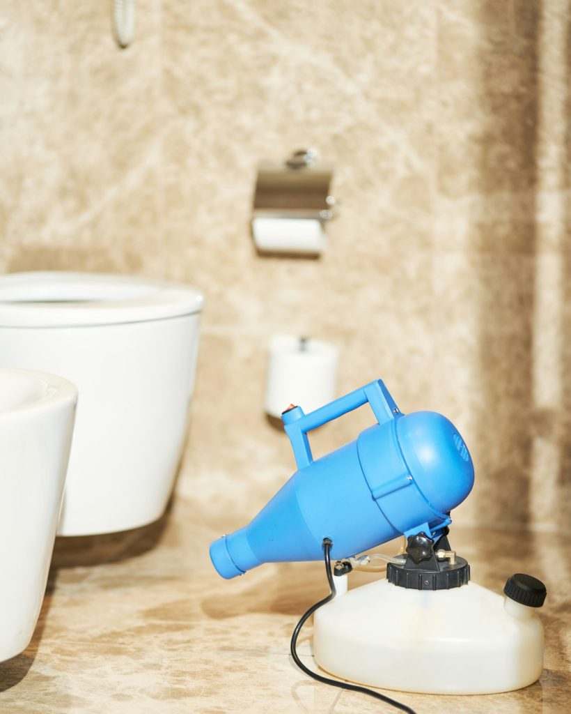 Professional hotel room disinfection service in bathroom
